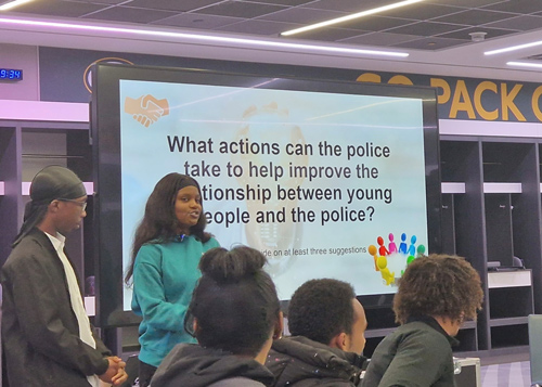 young people discussing police relationships on a screen displaying improvement actions